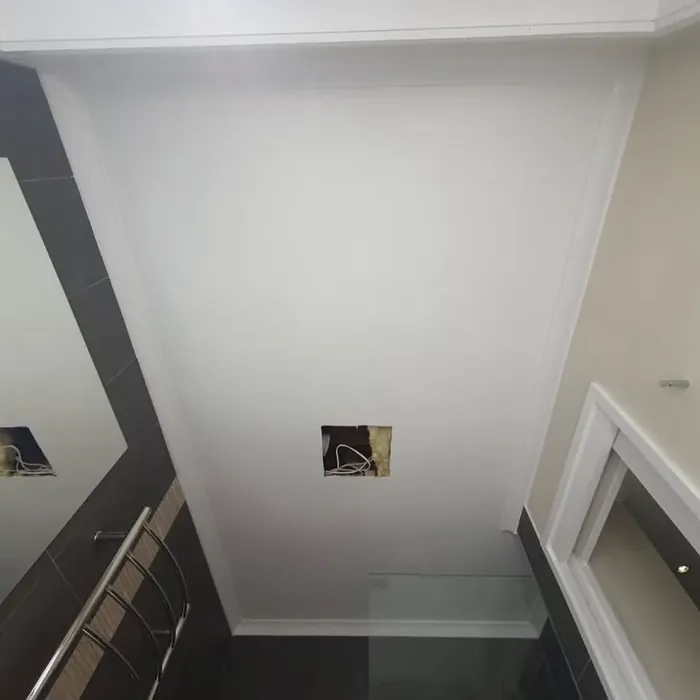 The same ensuite ceiling finished in an even white, with crisp lines against the cornice.